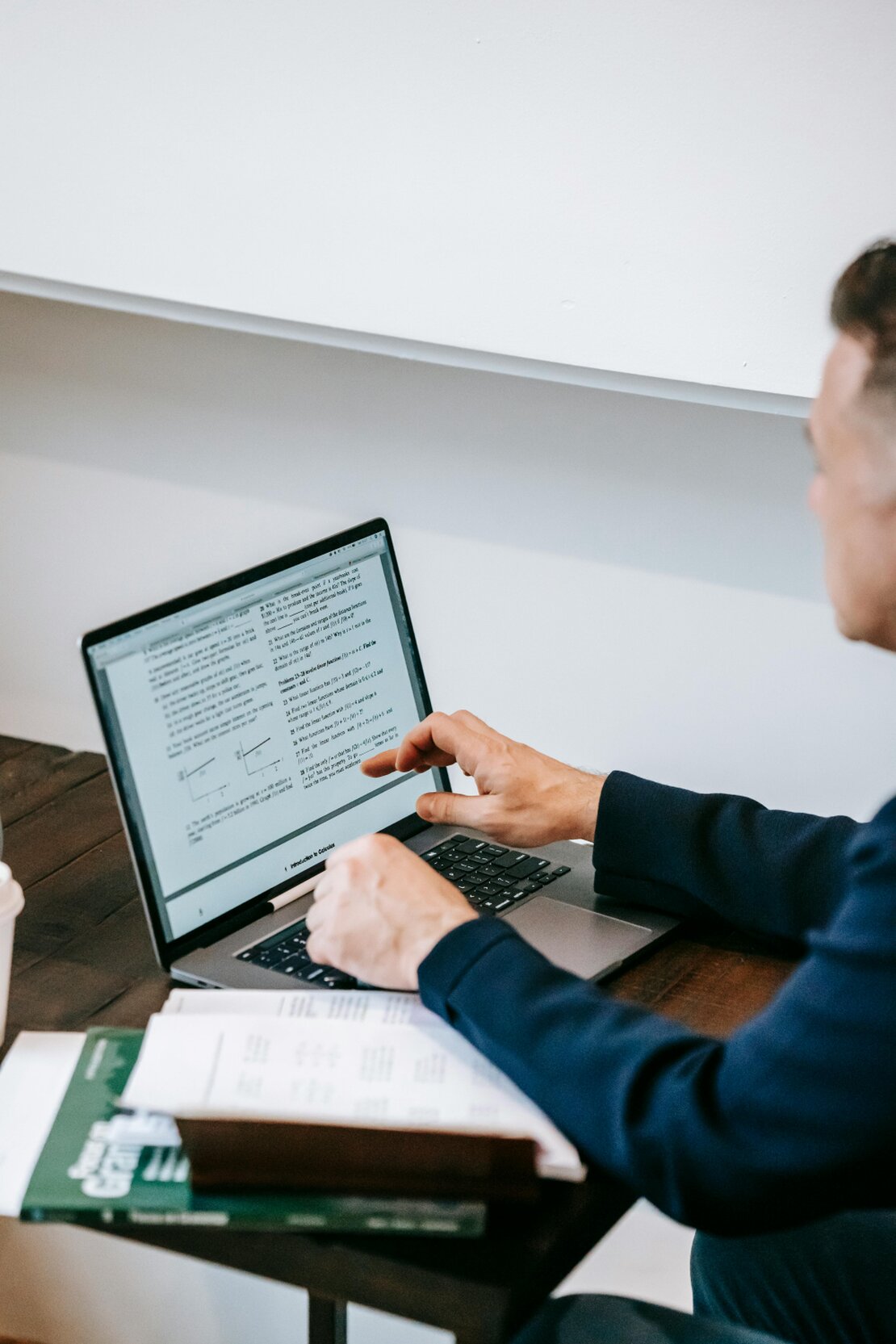 Person reading clinical hypnotherapy articles on a laptop